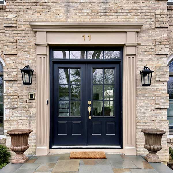 Front entry door replacement with black double doors installed by Warner Exteriors & Solar in New Jersey.