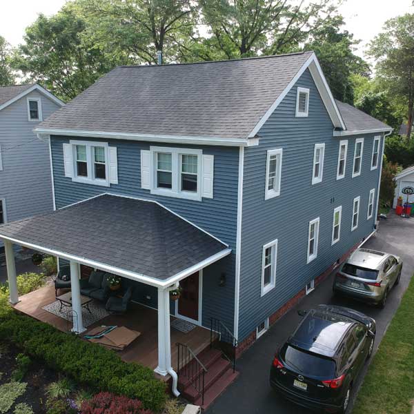 Full vinyl siding installation on a blue home in New Jersey completed by Warner Exteriors & Solar.